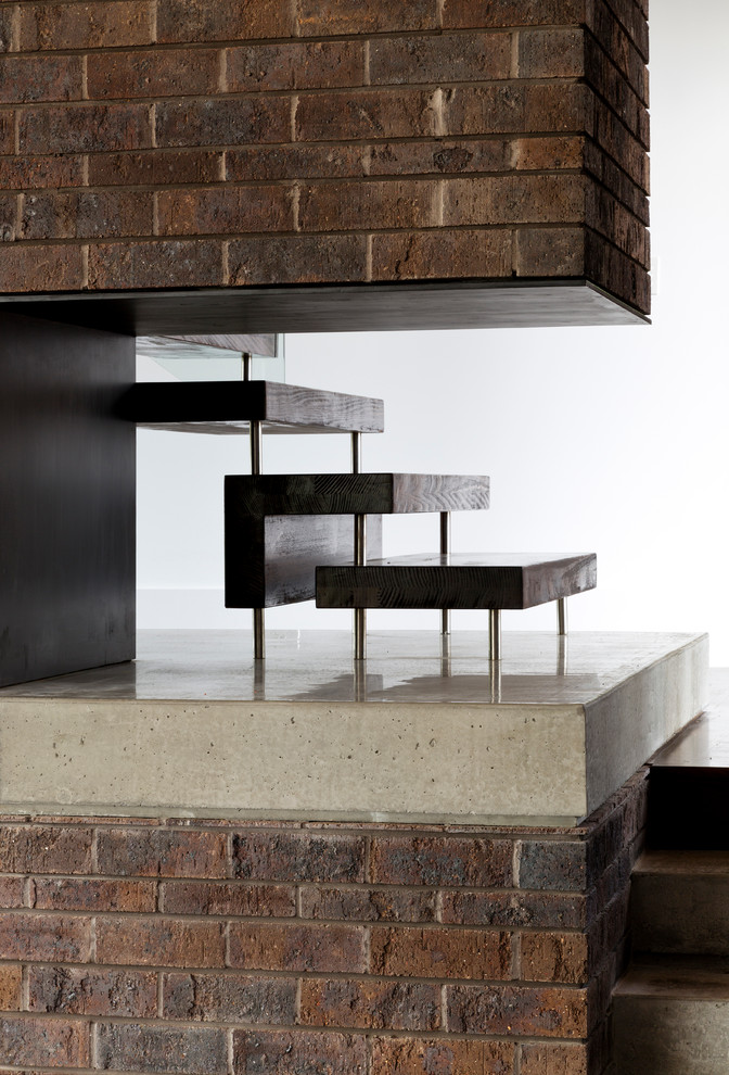 This is an example of a modern wood floating staircase in Brisbane with open risers.