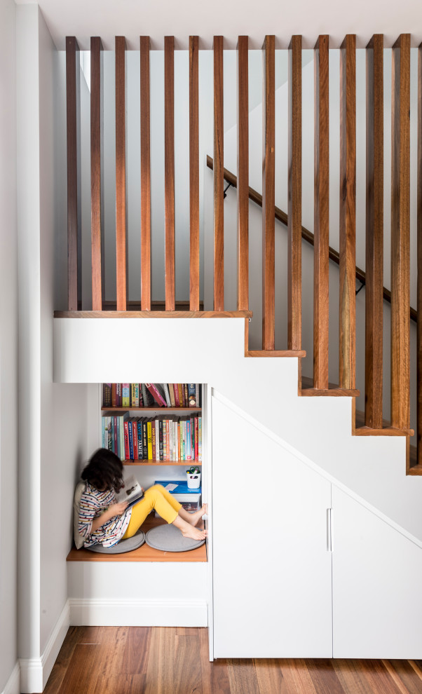 Medium sized contemporary wood u-shaped wood railing staircase in Sydney with wood risers.