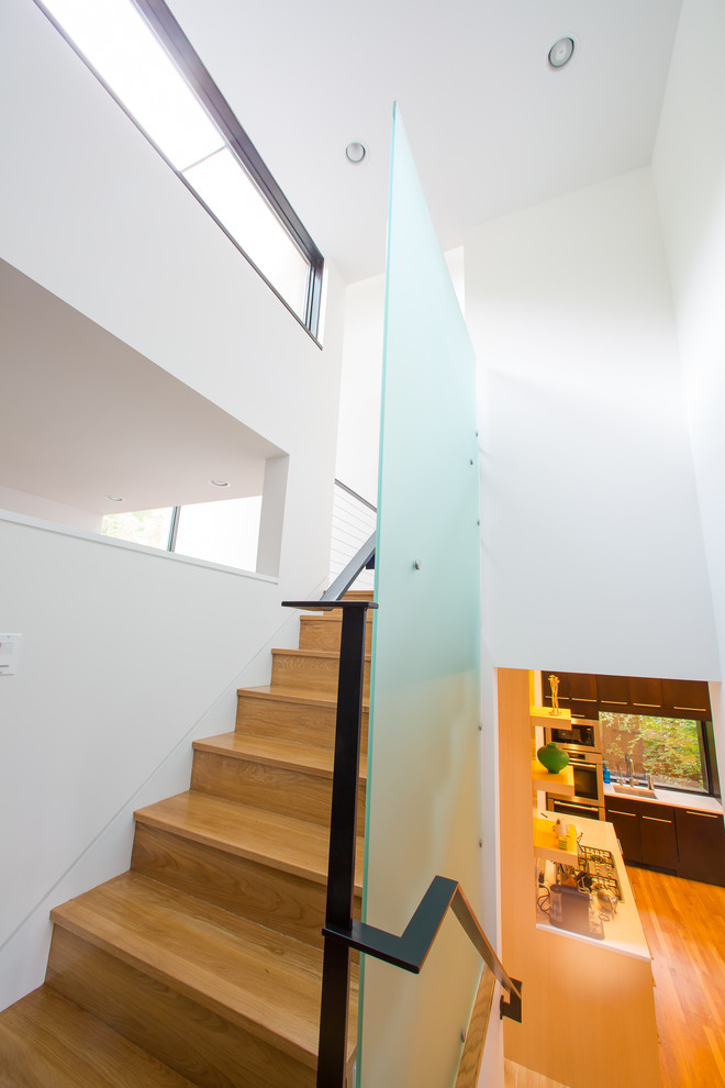 Foto de escalera en U contemporánea de tamaño medio con escalones de madera, contrahuellas de madera y barandilla de metal