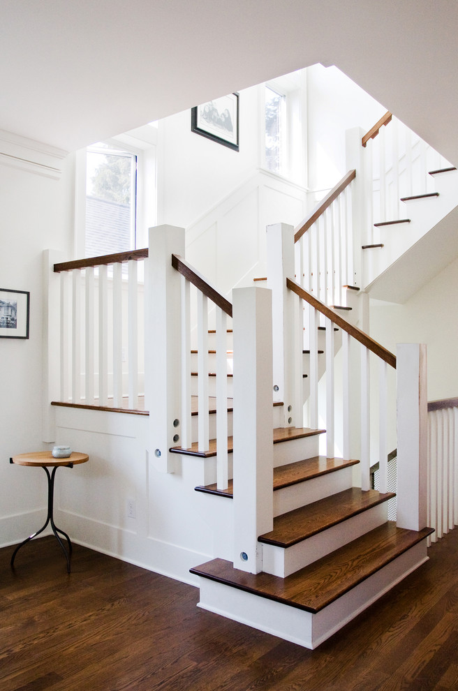 Arts and crafts wooden u-shaped staircase photo in Seattle with painted risers