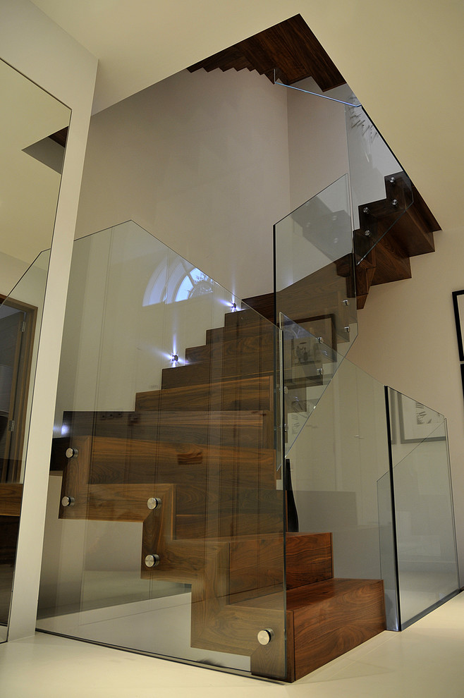 Example of a minimalist wooden staircase design in London with wooden risers