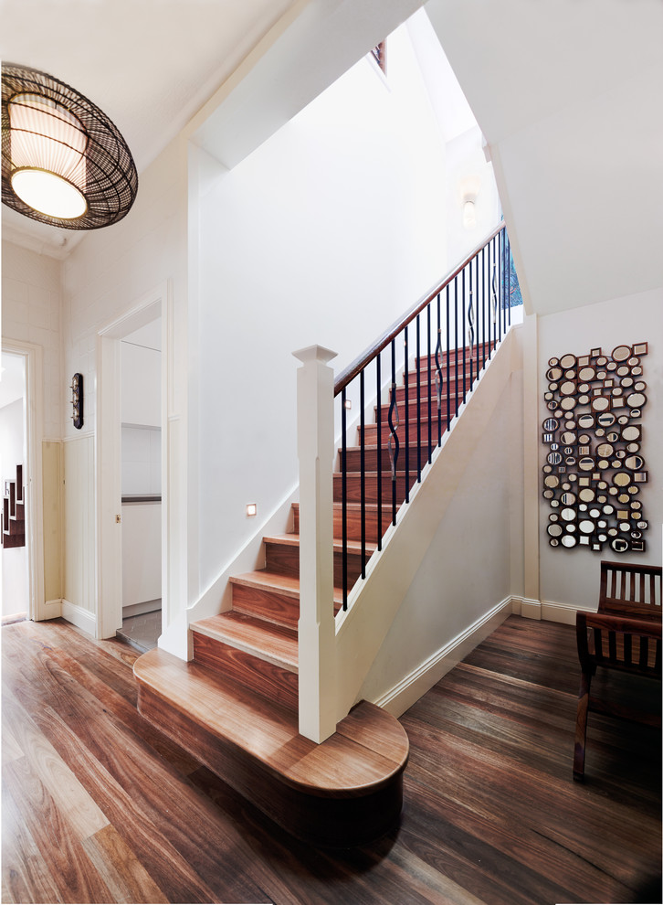 This is an example of a medium sized contemporary wood u-shaped staircase in Sydney with wood risers.