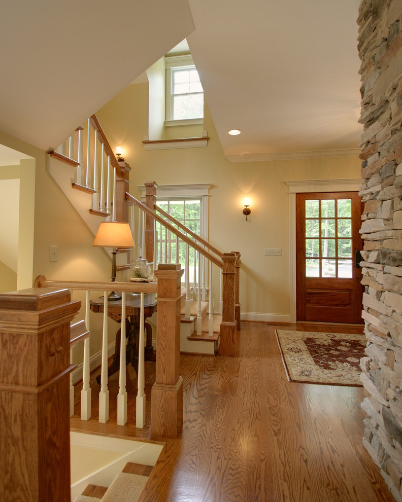 Example of a classic wooden wood railing staircase design in Columbus