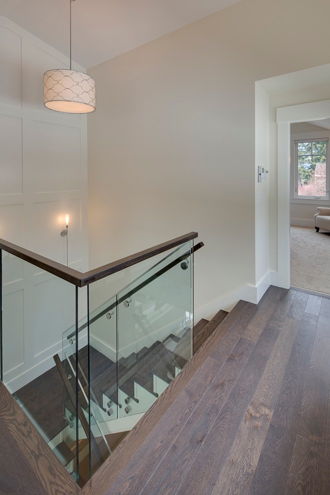 Example of a mid-sized transitional wooden u-shaped staircase design in Vancouver with painted risers