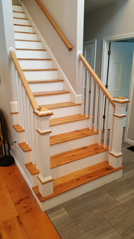Photo of a small classic wood straight staircase in Boston with wood risers.