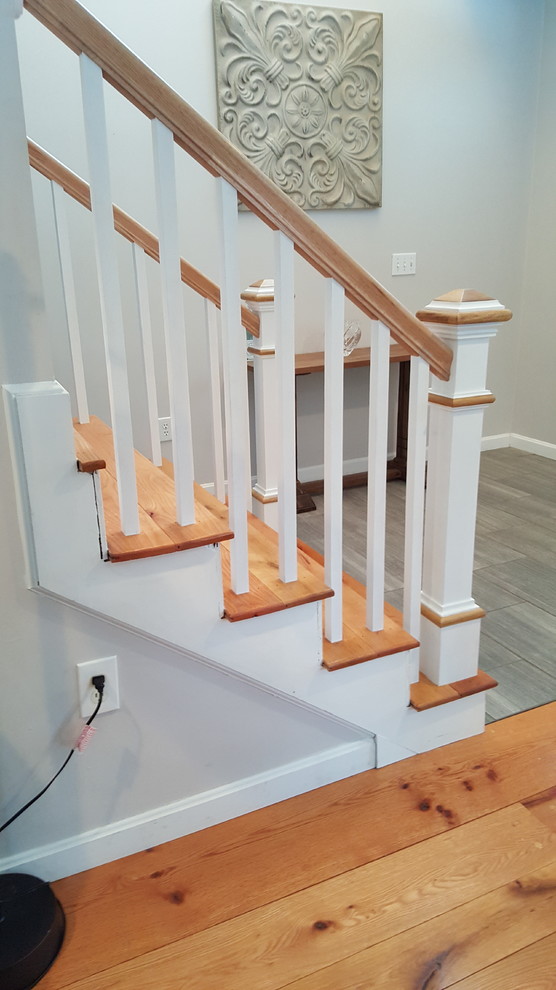 Small traditional wood straight staircase in Boston with wood risers.