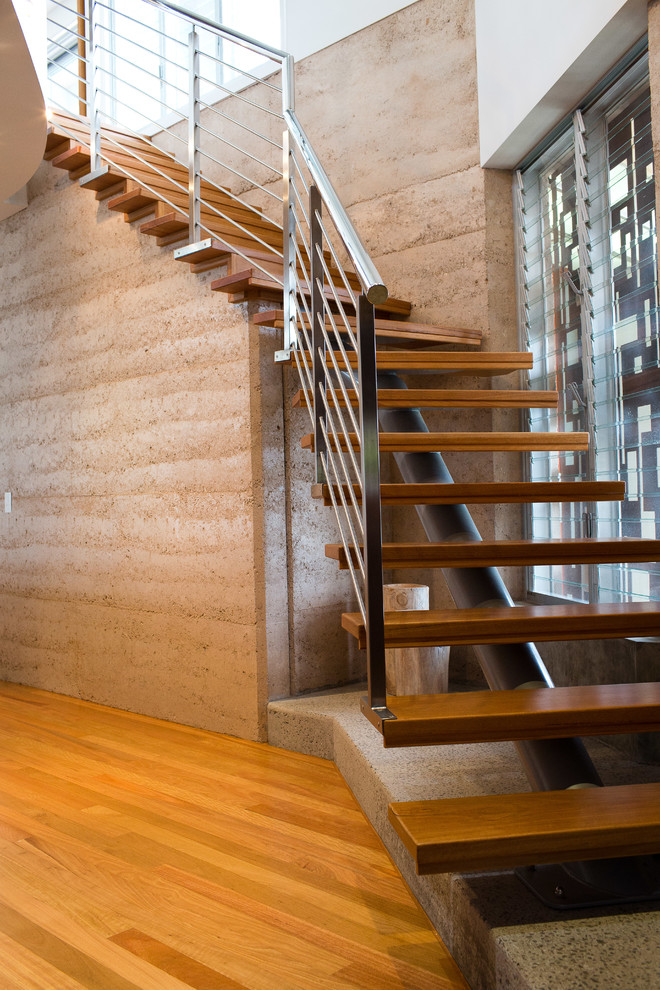 Photo of a contemporary wood staircase in Sunshine Coast with open risers.