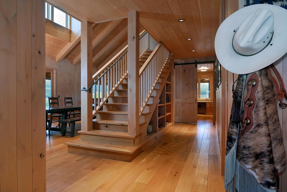 Ejemplo de escalera recta rústica con escalones de madera, contrahuellas de madera y barandilla de madera