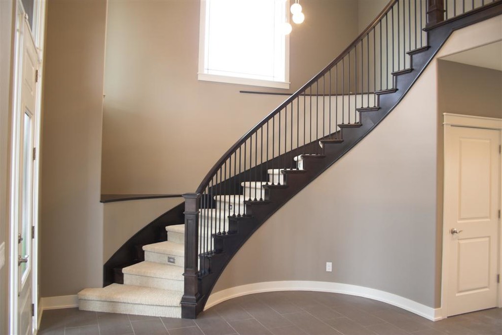 Inspiration for a traditional wood curved staircase in Omaha with wood risers.