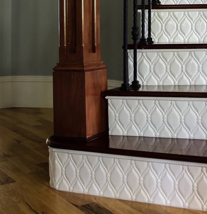 This is an example of a large classic wood curved staircase in Raleigh with tiled risers.