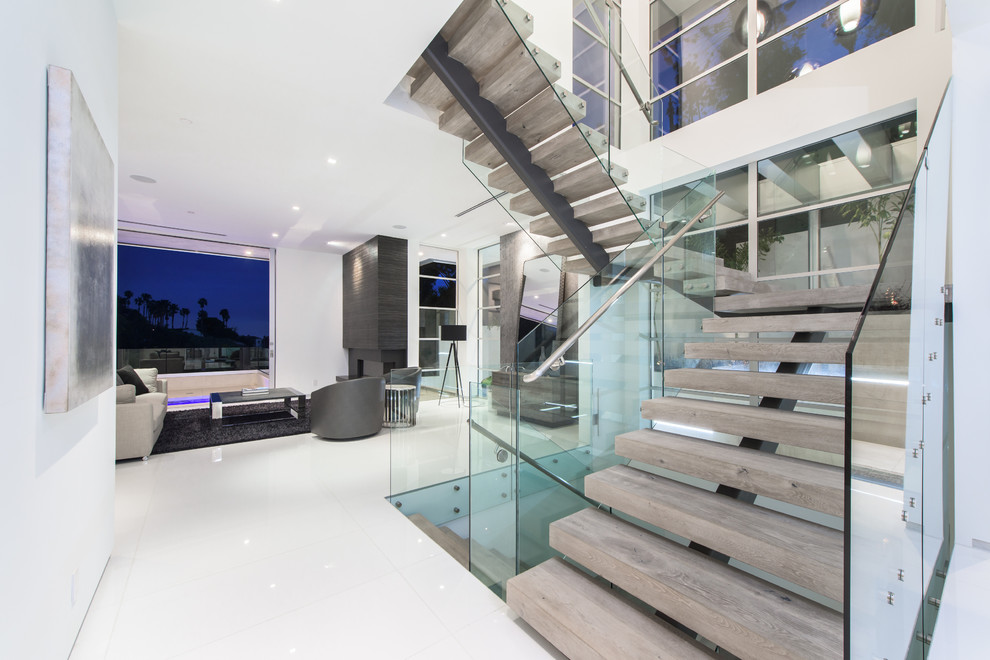 Inspiration for a contemporary wooden floating glass railing and open staircase remodel in Los Angeles