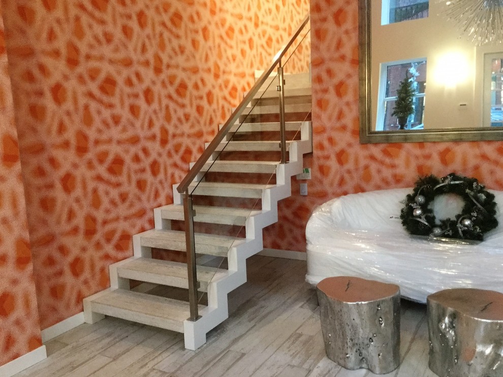 Design ideas for a small modern painted wood straight staircase in Montreal with open risers.