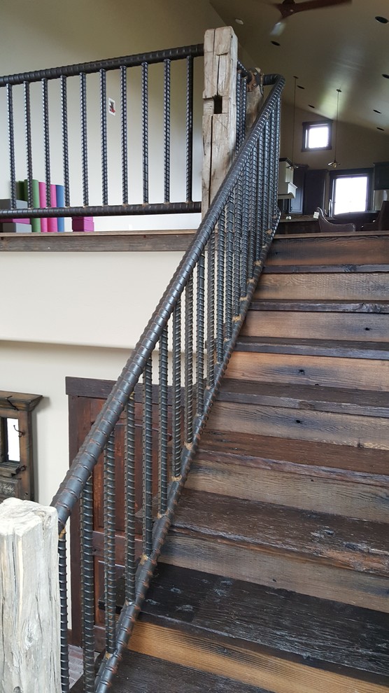 Photo of a large urban wood l-shaped metal railing staircase in Other with wood risers.