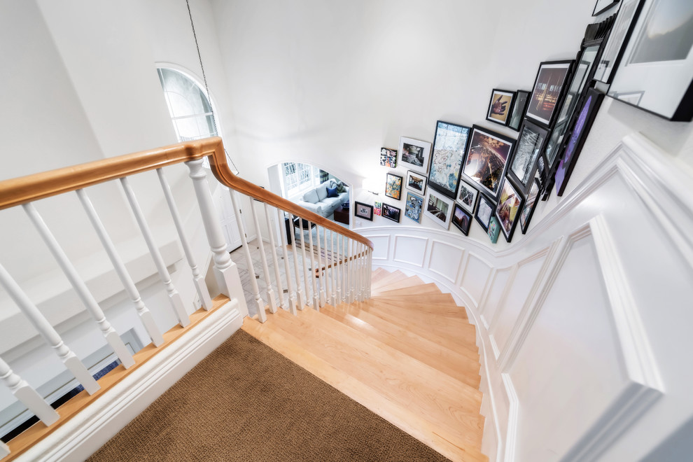 Example of a classic wooden curved staircase design in San Francisco