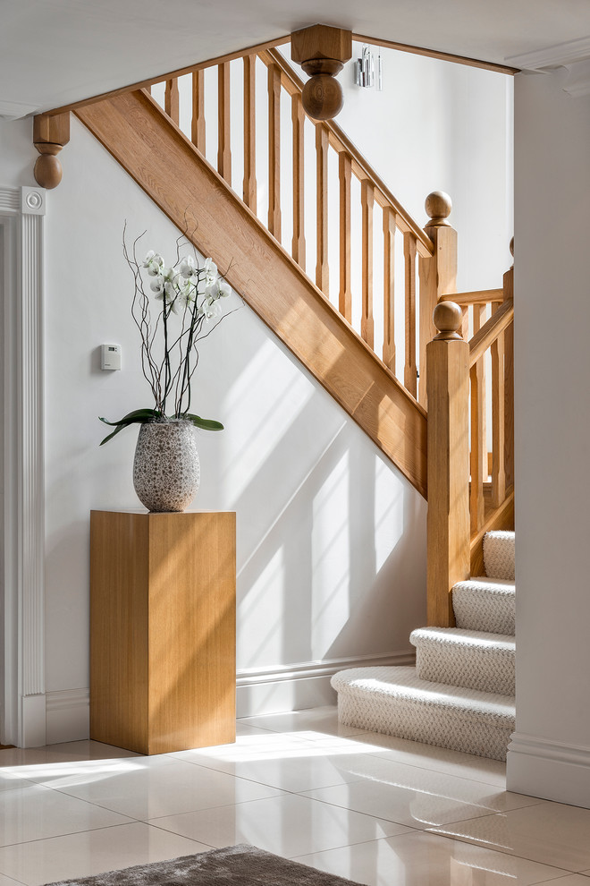 Example of a mid-sized classic carpeted u-shaped staircase design in Hampshire with carpeted risers