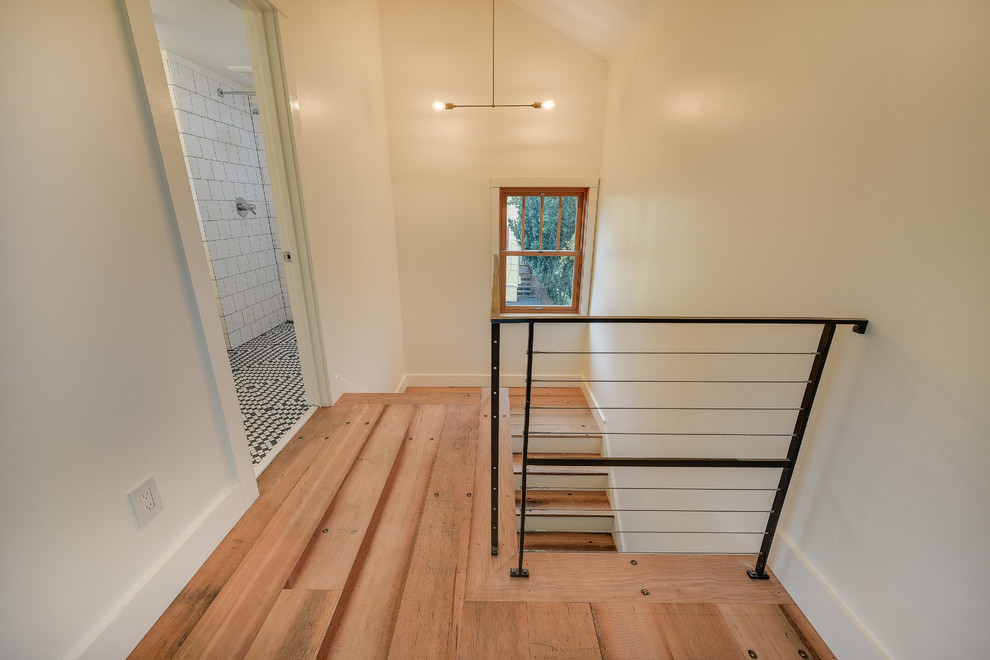 Inspiration for a mid-sized craftsman wooden u-shaped metal railing staircase remodel in Portland with painted risers
