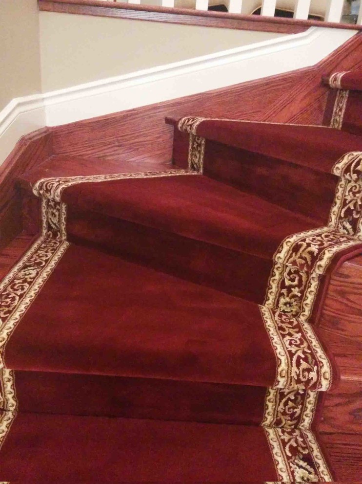 This is an example of a medium sized traditional carpeted curved staircase in Toronto with carpeted risers.