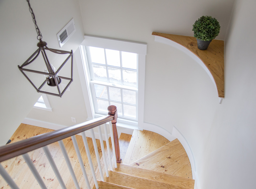 Design ideas for a small classic wood curved staircase in Boston with painted wood risers.
