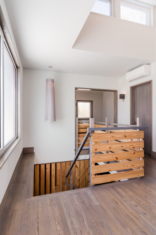 Inspiration for a small modern wood l-shaped metal railing staircase in Boston with wood risers.