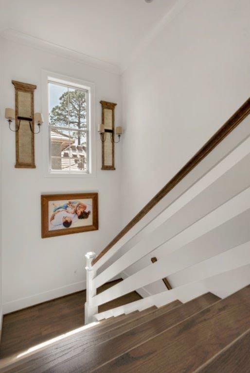Example of a large farmhouse wooden u-shaped wood railing staircase design in Miami with painted risers