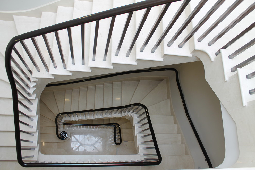 Photo of a medium sized contemporary tiled curved staircase in London with tiled risers.
