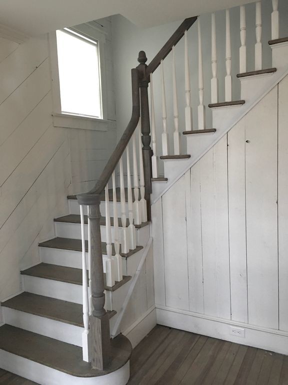 This is an example of a medium sized coastal wood l-shaped wood railing staircase in New York with wood risers.