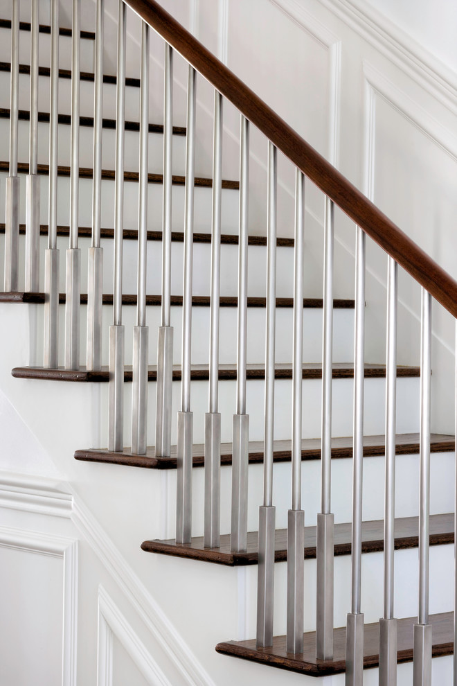 This is an example of a contemporary wood straight staircase in Austin with wood risers.