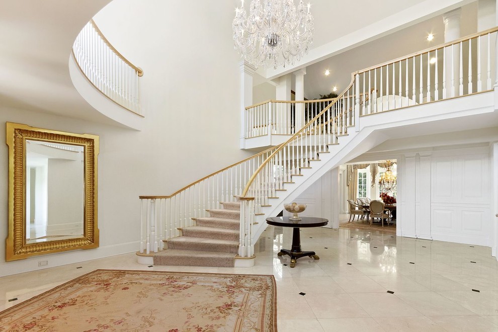 Staircase - huge traditional curved staircase idea in New York