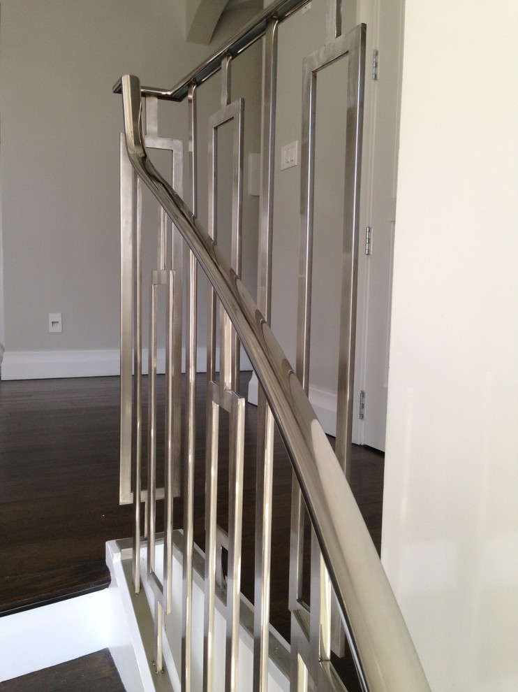 Mid-sized trendy wooden curved staircase photo in New York with painted risers