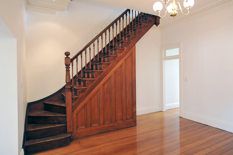 This is an example of a victorian wood l-shaped staircase in Sydney with wood risers.