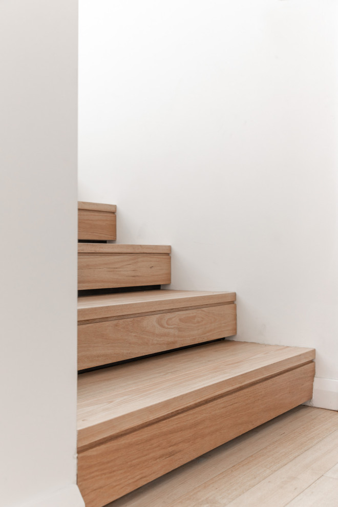 Réalisation d'un escalier design en U de taille moyenne avec des marches en bois, des contremarches en bois et un garde-corps en bois.