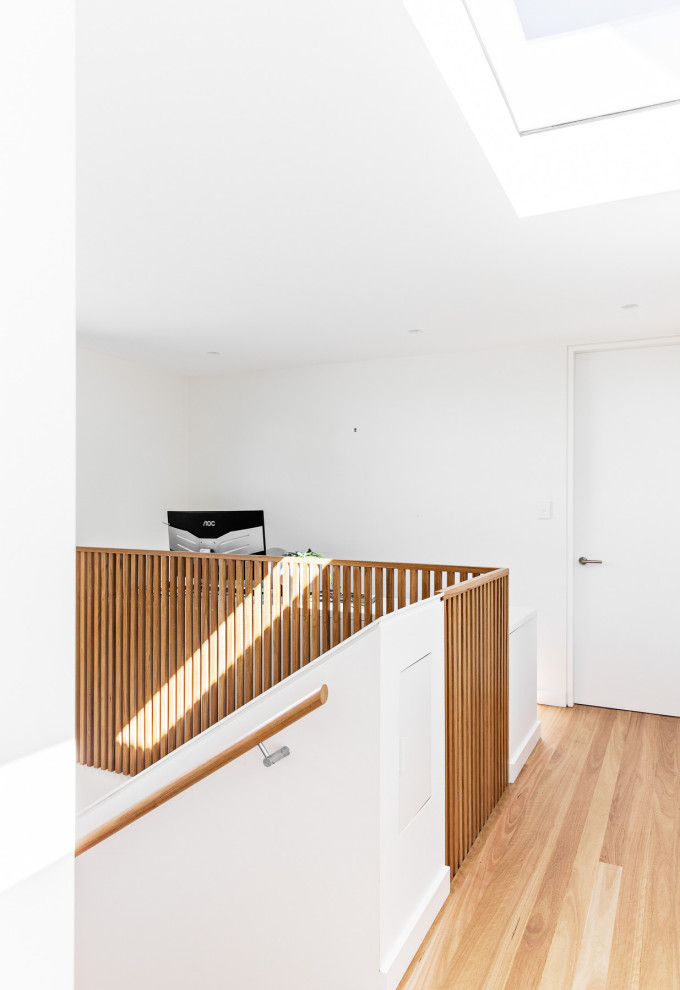 Design ideas for a medium sized contemporary wood u-shaped wood railing staircase in Sydney with wood risers.