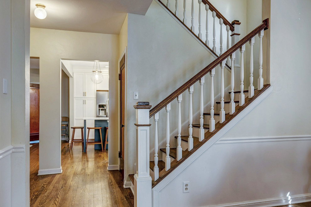 Staircase - small transitional wooden u-shaped wood railing staircase idea in St Louis with painted risers