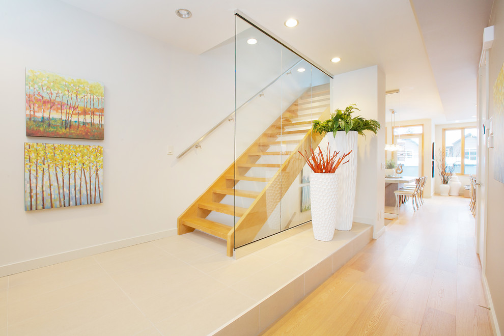 Contemporary wood straight staircase in Calgary with open risers.