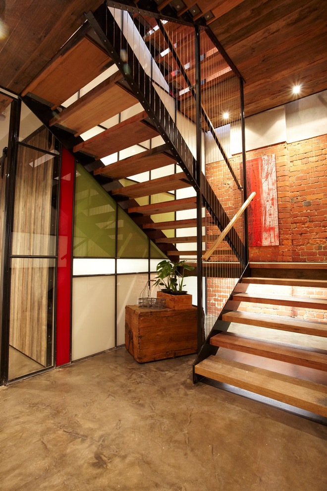 Photo of an industrial wood u-shaped staircase in Melbourne with open risers.