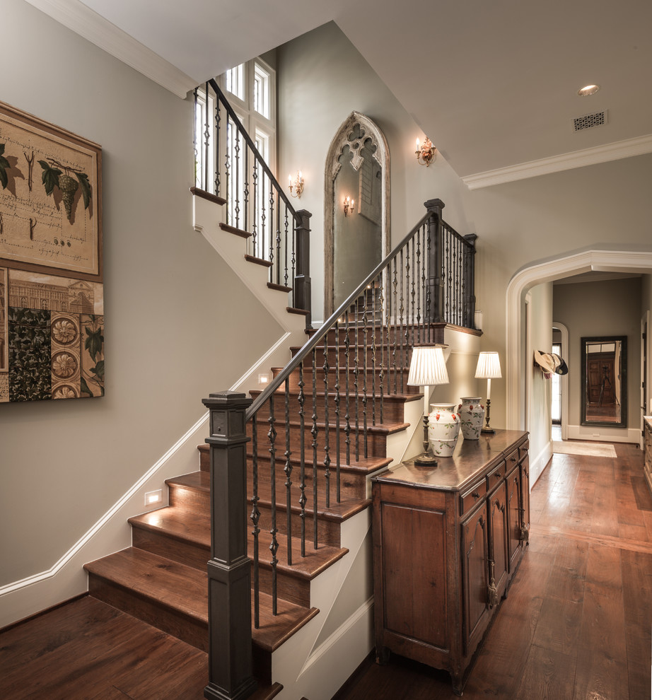 Staircase - large traditional wooden u-shaped staircase idea in Houston with wooden risers