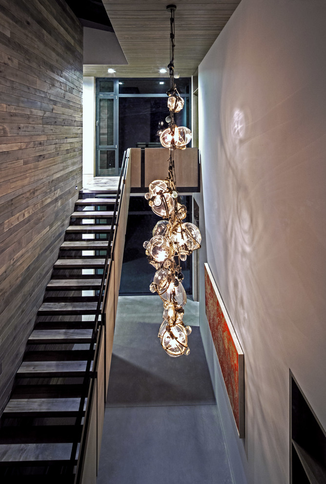 Inspiration for a contemporary wood straight staircase in New York with open risers.