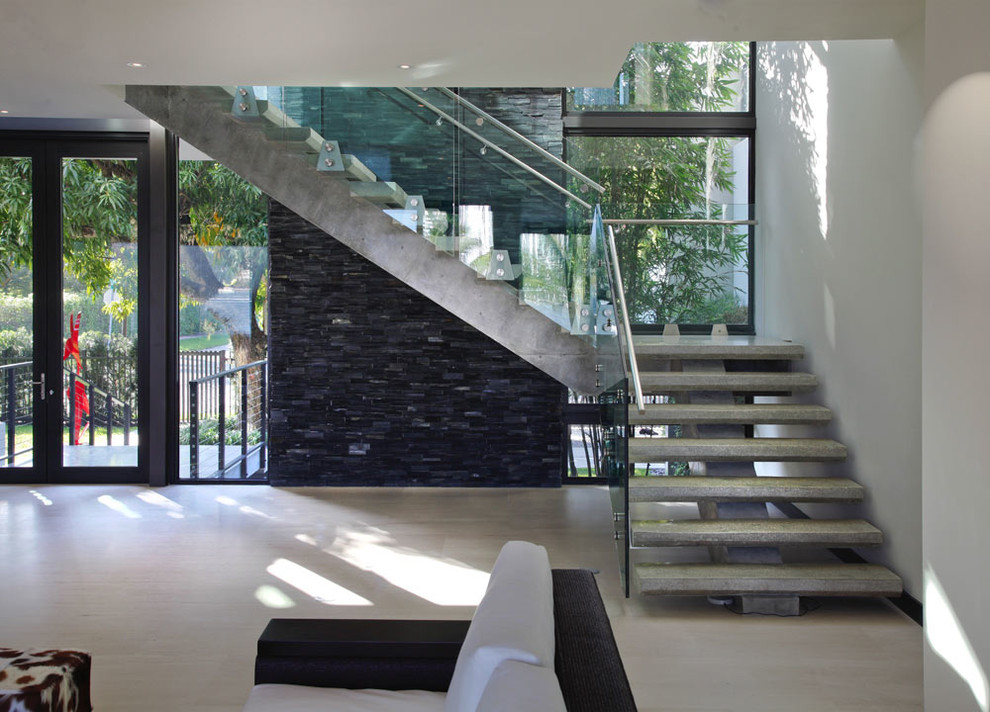 Expansive contemporary floating metal railing staircase in Miami with open risers.