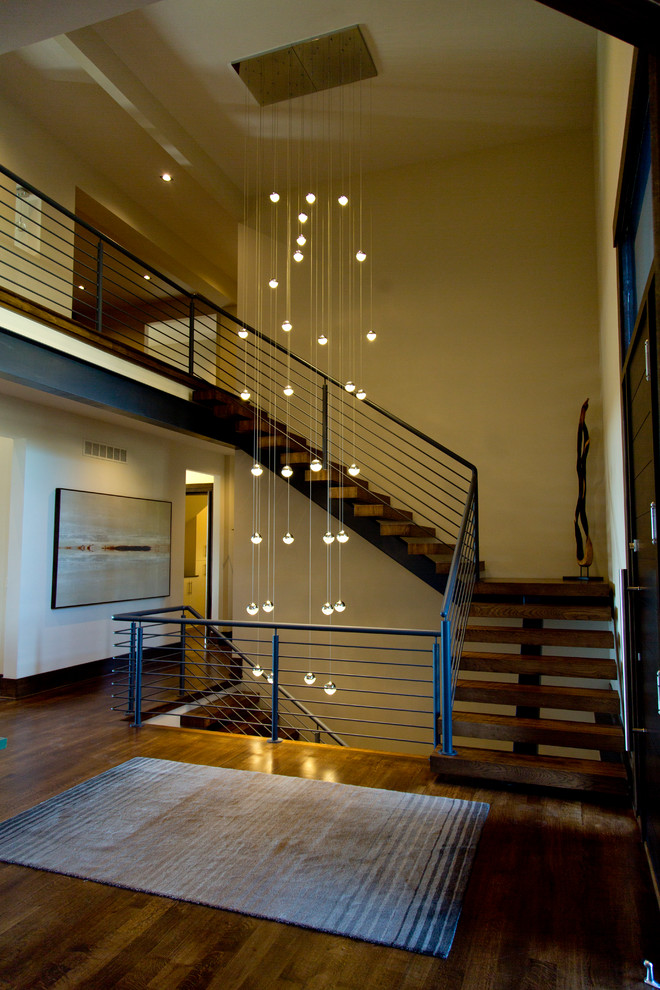 Photo of a large traditional wood curved staircase in Kansas City with wood risers.