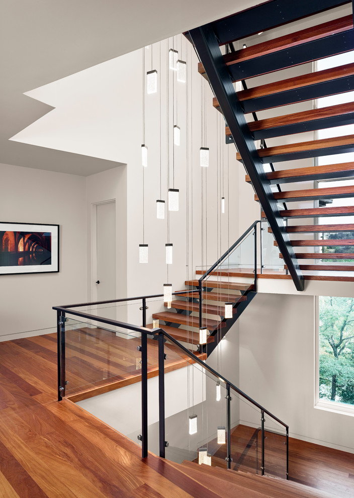Inspiration for a contemporary wood u-shaped staircase in Austin with open risers.
