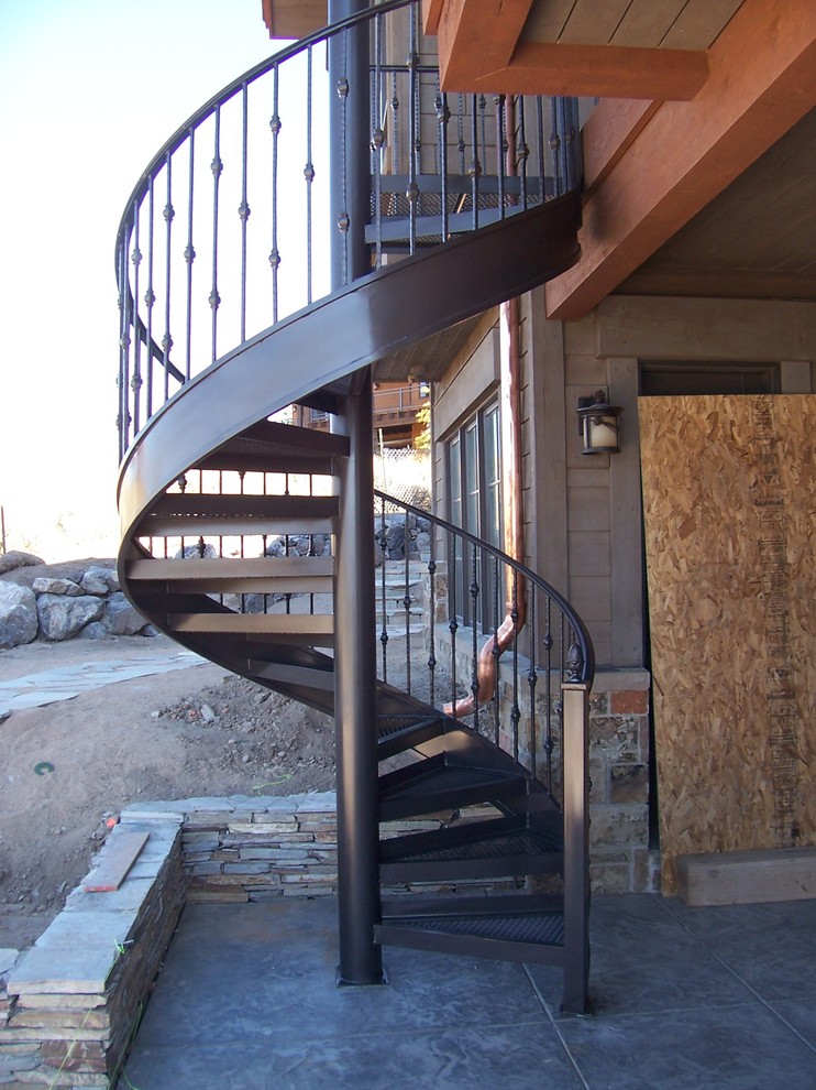 This is an example of a medium sized modern metal spiral staircase in Salt Lake City with open risers.