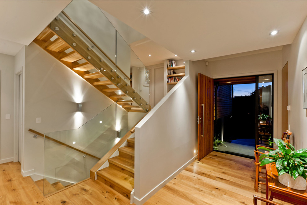 Medium sized contemporary wood u-shaped staircase in Auckland with wood risers.