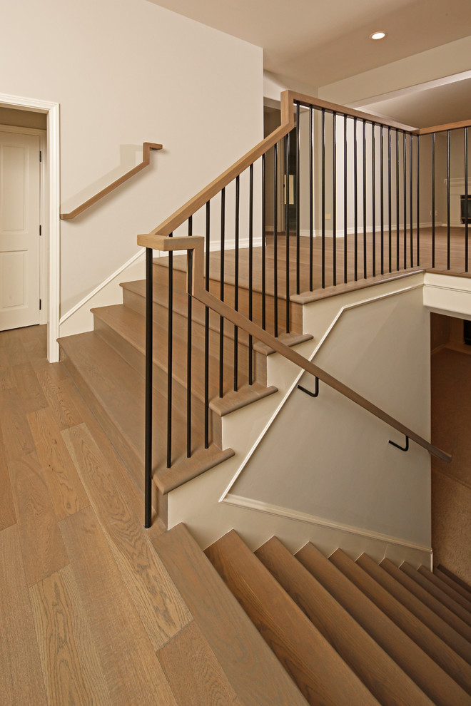 Imagen de escalera en L actual grande con escalones de madera y contrahuellas de madera