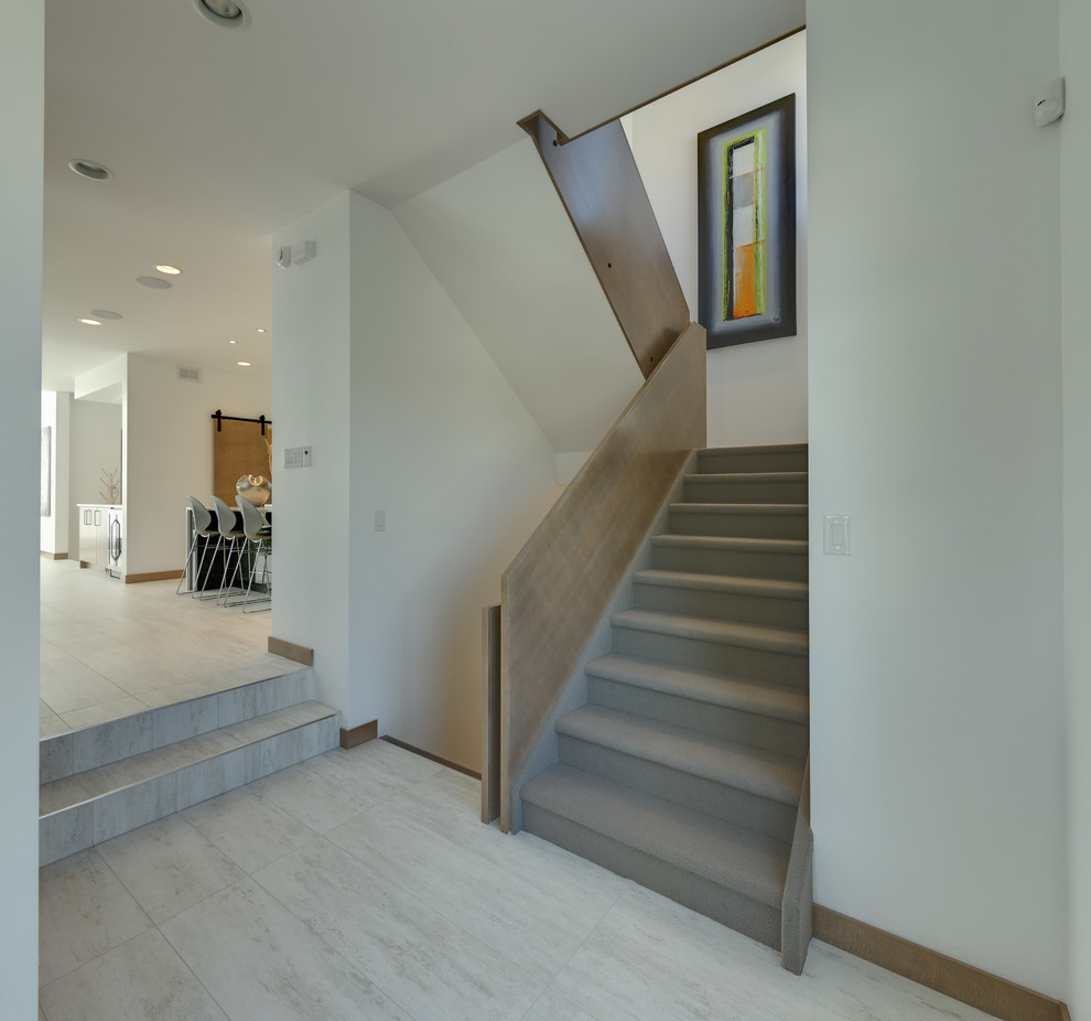 Photo of a small modern carpeted u-shaped staircase in Other with carpeted risers.