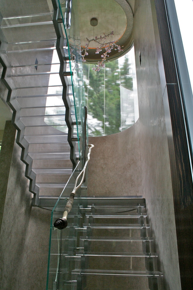Exemple d'un escalier sans contremarche moderne en L avec des marches en acrylique.