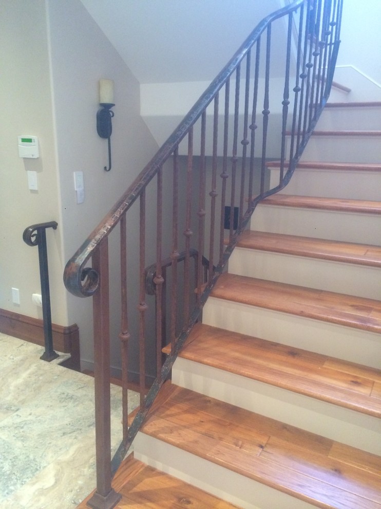 This is an example of a rustic wood curved staircase in San Francisco with wood risers.