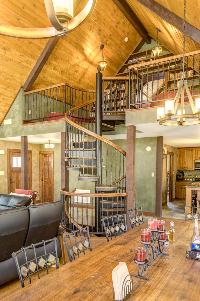 Example of a large mountain style wooden spiral staircase design in Indianapolis with metal risers