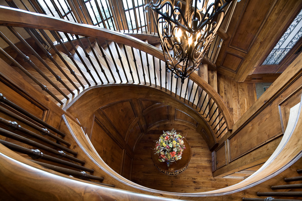 Inspiration for a huge timeless wooden curved staircase remodel in Salt Lake City with wooden risers