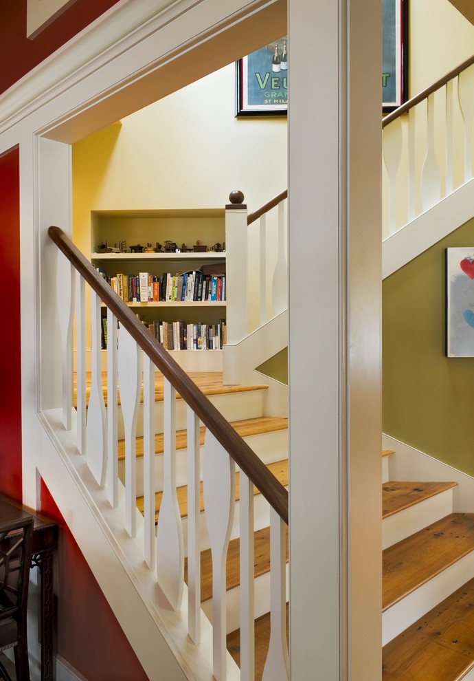 Mountain style wooden wood railing staircase photo in Burlington with painted risers