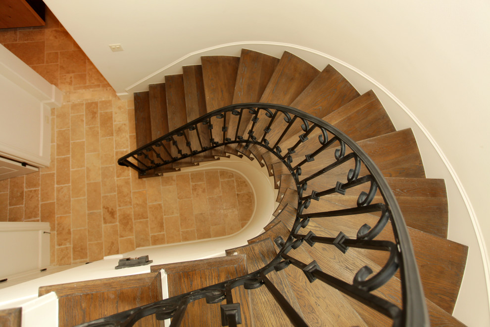 Ejemplo de escalera en U mediterránea grande con escalones de madera y contrahuellas de madera pintada